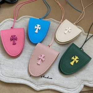 Detailed view of leather cross magnetic eyewear clips in various pastel colors