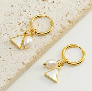 Detail of 18K gold earrings with triangular shell inlay and natural baroque pearl charms