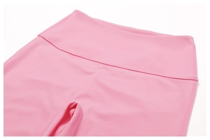 Detail showing the flatlock stitching and smooth high-waisted band of pink yoga pants