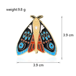 Detailed view of colorful enamel moth brooch with golden edges and 3.9 cm dimensions