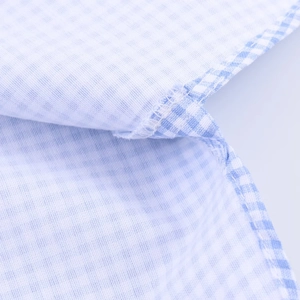 Detailed close-up showing precision stitching and light blue gingham fabric texture