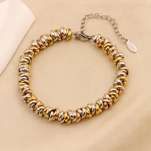 Macro shot of tricolor woven stainless steel chain bracelet with lobster clasp and tag