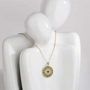 Detailed view of evil eye pendant necklace with colorful zircon stones on gold chain