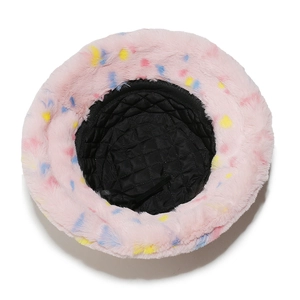 Pink faux fur bucket hat with colorful dots showing black quilted lining and soft texture