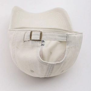 Detail view of cotton baseball cap back with antique bronze metal adjustment buckle