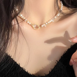 Close-up of double-layer pearl and crystal necklace worn on woman neck for detail view