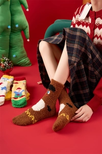 Close-up of thick coral fleece Christmas socks featuring cute reindeer embroidery detail