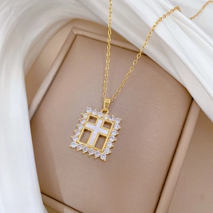Macro detail of gold-plated square cross pendant with white shell and zircons
