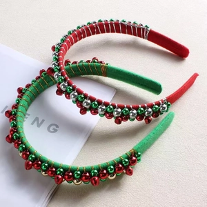 Detail of festive Christmas headbands with metallic red, green, and gold bells on velvet
