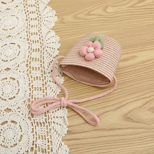 Pink woven straw bag for girls featuring a 3D floral accent and soft rope strap