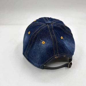 Rear view of dark blue denim baseball cap with contrast stitching and metal buckle