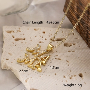 Close-up of 18K gold plated MAMA necklace with size specs on a stone background