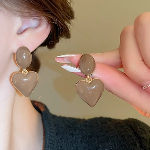 Detail view of coffee brown heart drop earrings with vintage oil-dripped metal finish