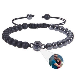 Detailed macro view of an adjustable woven bracelet featuring a custom photo projection bead