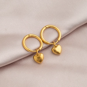 Minimalist gold heart hoop earrings on pink silk fabric, polished stainless steel jewelry