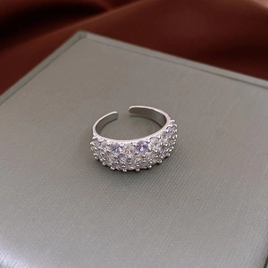 Detailed macro view of silver open ring with multi-row purple and white zircon pave setting