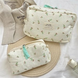 Detail of floral quilted cotton makeup bag set with green zippers and elegant french style