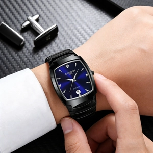 Business man wearing black rectangular watch with blue dial and calendar feature