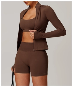 Detail view of chocolate brown seamless yoga jacket with high neck and thumbhole cuffs