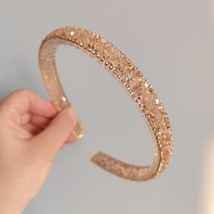 Detailed view of handmade champagne gold headband with sparkling rhinestone crystals