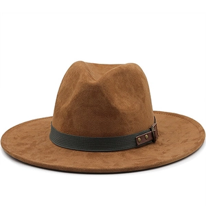 Detail of suede cowboy hat with dark grey woven band and metal rivets on brown fabric