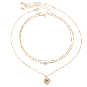 Detailed shot of layered gold pearl necklaces with a blue rhinestone flower pendant