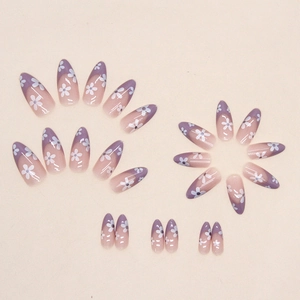 French almond press-on nails with lavender purple tips and white daisy floral patterns
