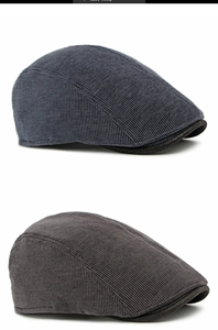 Detailed close-up of corduroy beret hats in navy and brown showing fabric texture