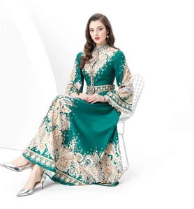 Detail of white lace cuffs on a green paisley maxi dress with vintage palace style