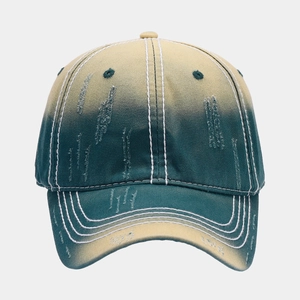 Detailed view of yellow and green gradient distressed baseball cap with ripped details