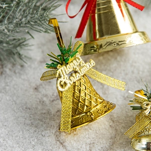 Golden Christmas bells with Merry Christmas lettering on pine branches with snow