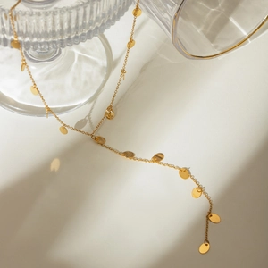 Detail of 18k gold plated stainless steel long chain necklace with round sequin charms
