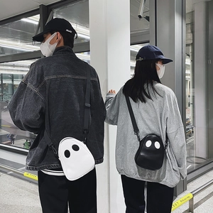 Matching set of black and white ghost-shaped PU leather crossbody bags with adjustable straps