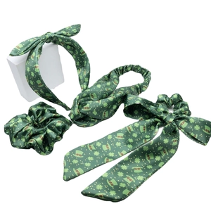 Saint Patrick's Day green headband set with clover patterns and ribbon on white background