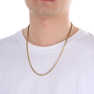 3mm gold snake chain necklace for men and women on a white T-shirt profile view