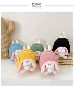 Detail view of colorful canvas kids backpacks with 3D plush long-eared bunny ornaments