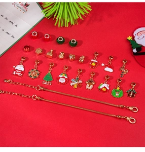 DIY Christmas bracelet kit with festive charms and golden chains on red background