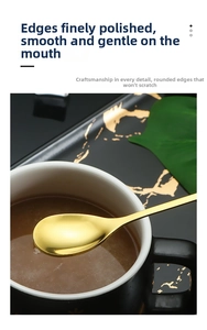 Macro detail of golden stainless steel leaf spoon resting on a black coffee cup