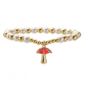 Fashionable gold beaded bracelet with pearls and a red enamel mushroom pendant charm