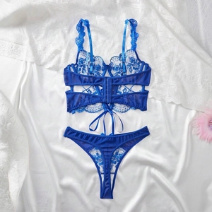 Detailed view of floral lace embroidery and sheer mesh on royal blue lingerie set