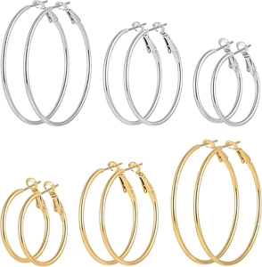 Detail view of round hoop earrings set in gold and silver colors with three distinct sizes