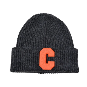 Detailed close-up of dark grey knit beanie with orange embroidered letter C patch detail