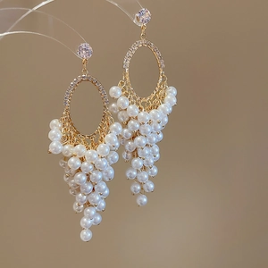 Detailed view of grape cluster pearl earrings with cubic zirconia and gold plating