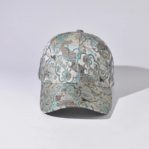 Detail of silk-like jacquard fabric on baseball cap featuring Chinese cloud patterns