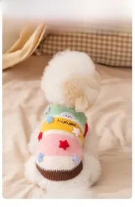 Detail of colorful striped dog knit sweater with star applique on white poodle