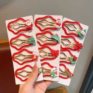 12-piece Christmas hair clip set featuring Santa, snowman, and tree on red wavy clips