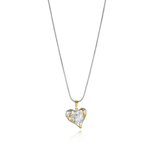 Detailed macro of a two-tone hammered heart pendant necklace on silver chain