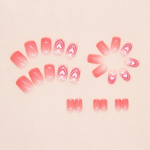 Detail of pink gradient press-on nails with sweet heart patterns in a 24-piece set