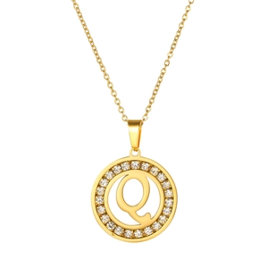 Detailed close-up of a gold-plated necklace with a crystal-encrusted letter Q pendant