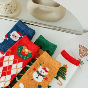 Detailed close-up of fluffy coral fleece Christmas socks with festive patterns and textures